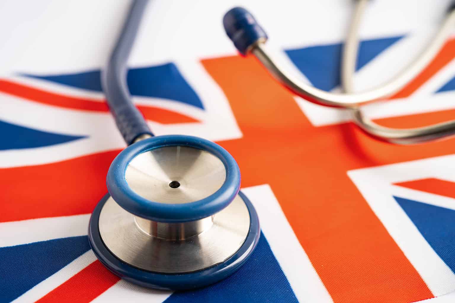 Stethoscope on United Kingdom flag background, Business and finance concept.